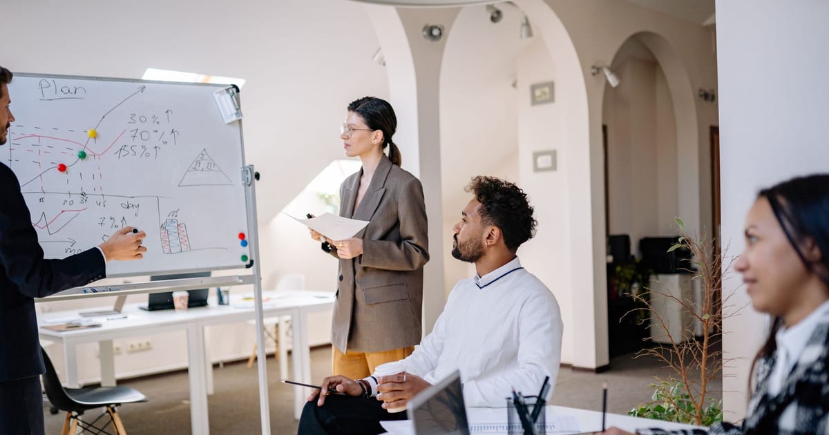 Colleagues discussing ideas during a team meeting in a modern office