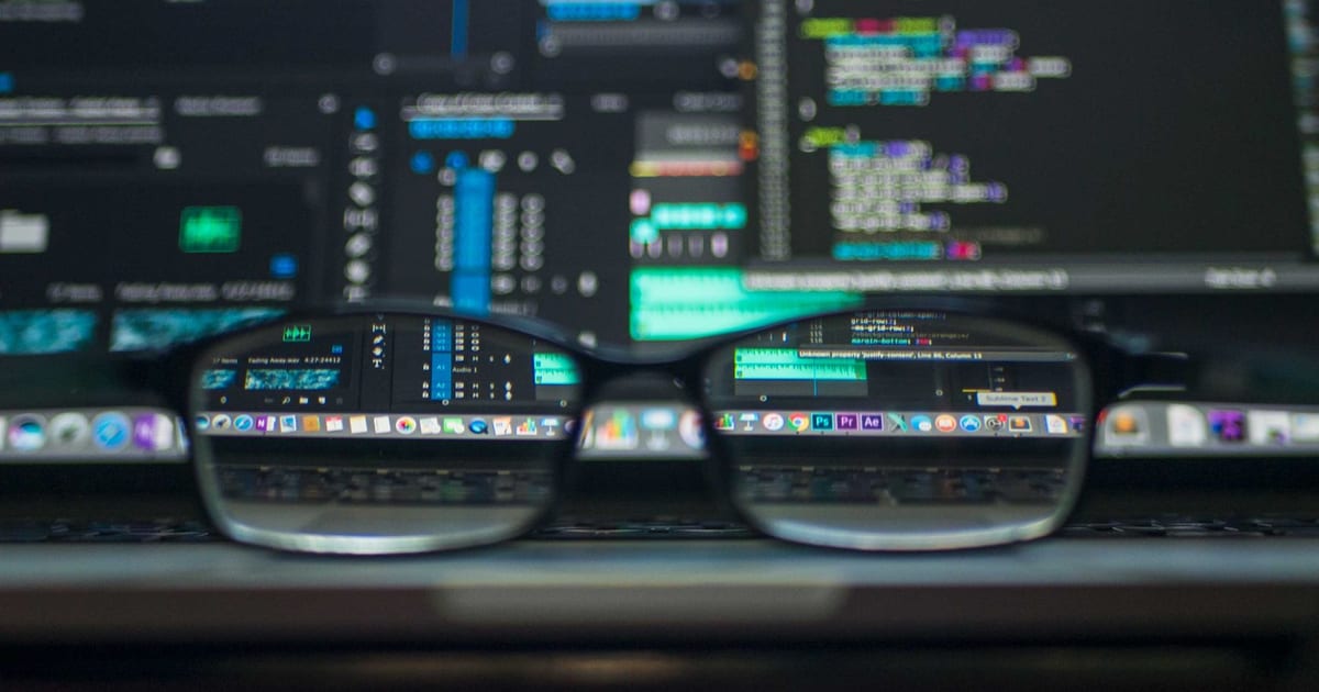 Backend developer reviewing server code and API logs on a monitor