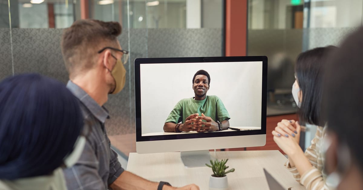 Distributed engineering team collaborating across time zones on a video call