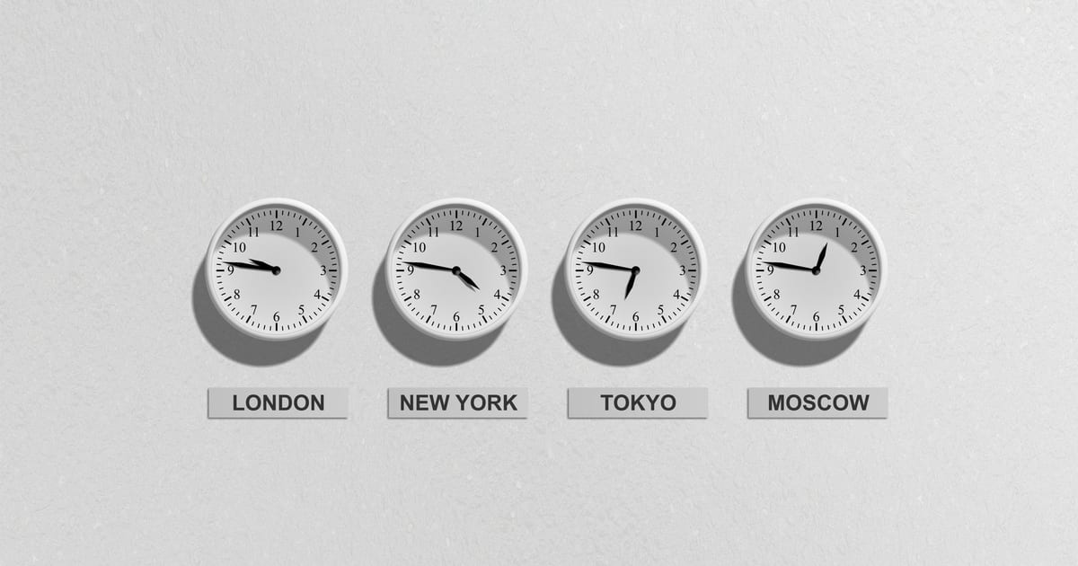 Four wall clocks showing the time in London, New York, Tokyo and Moscow
