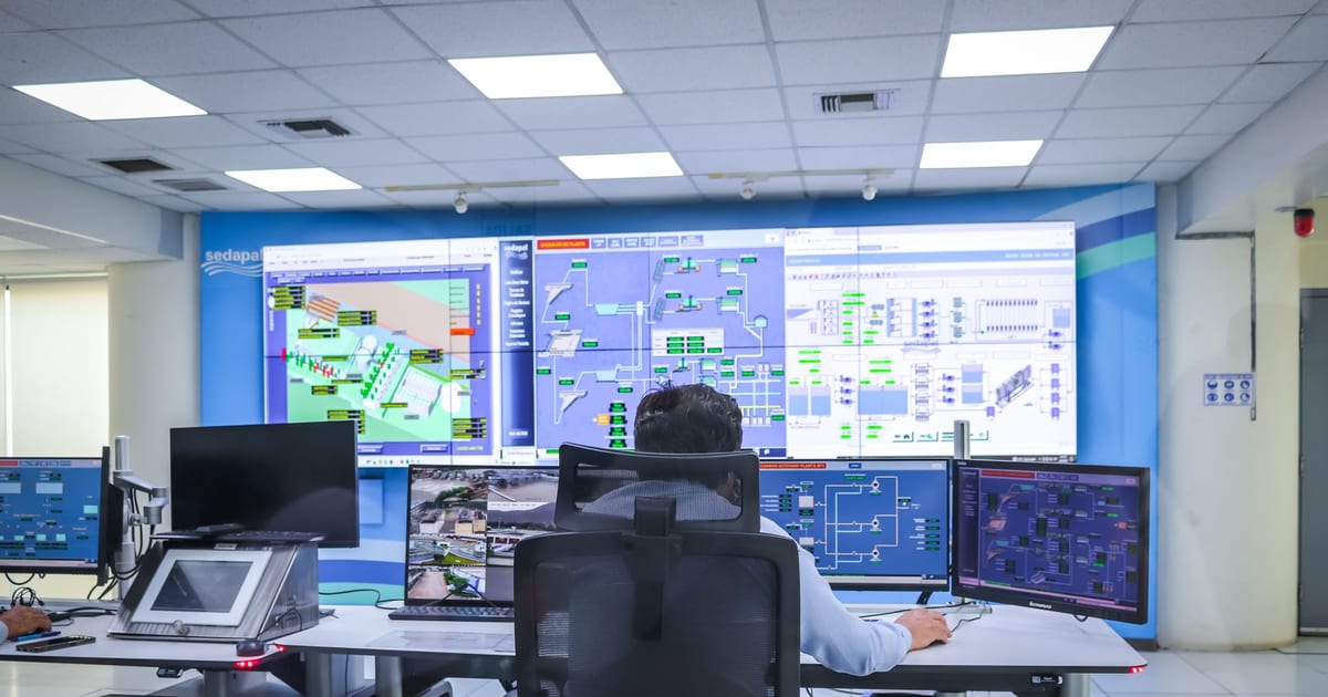 Operations team monitoring service dashboards and uptime metrics